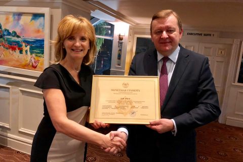 Ambassador Sergei Aleinik bestows Adi Roche with a certficiate of distinction